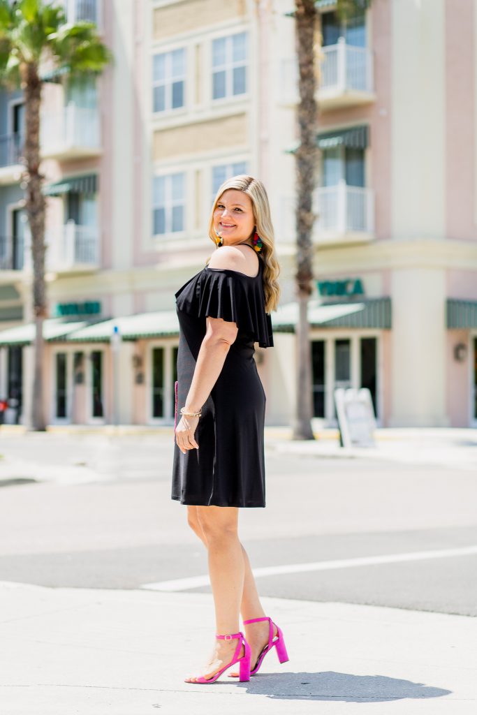 Black Dress and Pink Shoes Outfit featured by top Orlando fashion blog, Fabulously Overdressed: image of a woman wearing a Ross off the shoulder black dress and pink shoes.